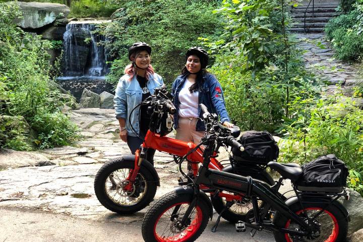 a person standing next to a motorcycle