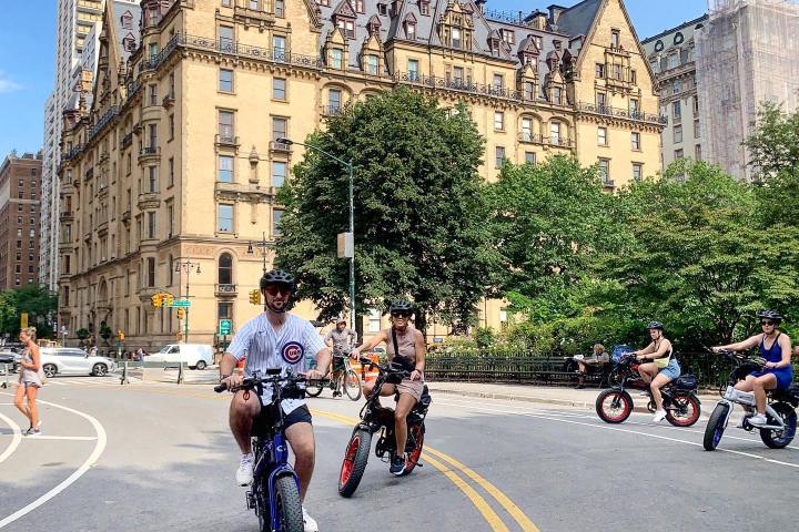 a group of people riding motorcycles on a city street