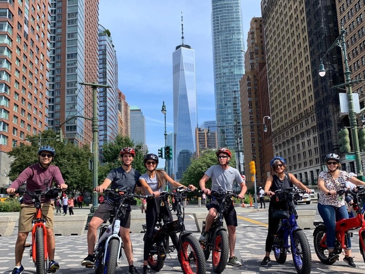 a group of people riding bikes on a city street