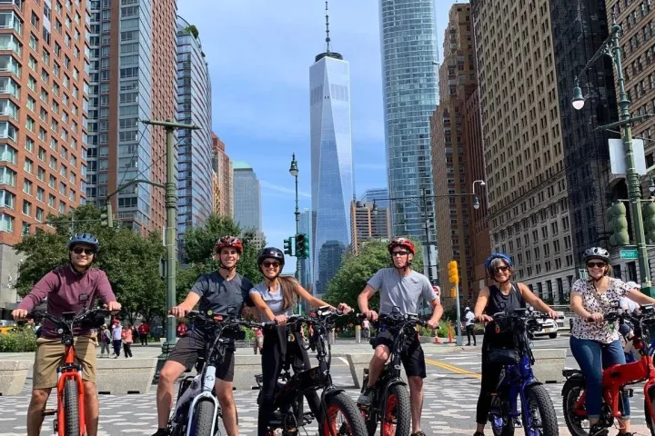 a group of people riding bikes on a city street