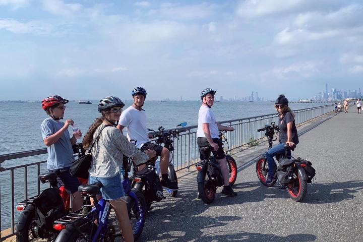 a group of people standing around a motorcycle