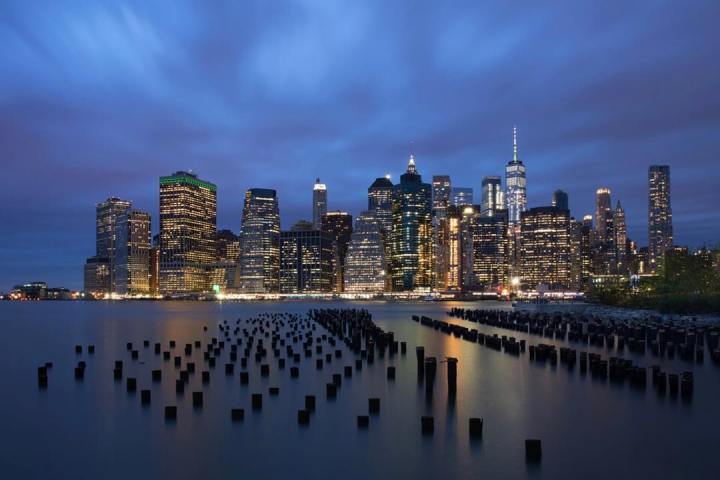 a large body of water with a city in the background