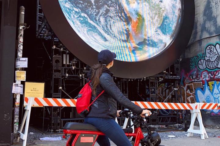 a person sitting on a motorcycle in front of a building