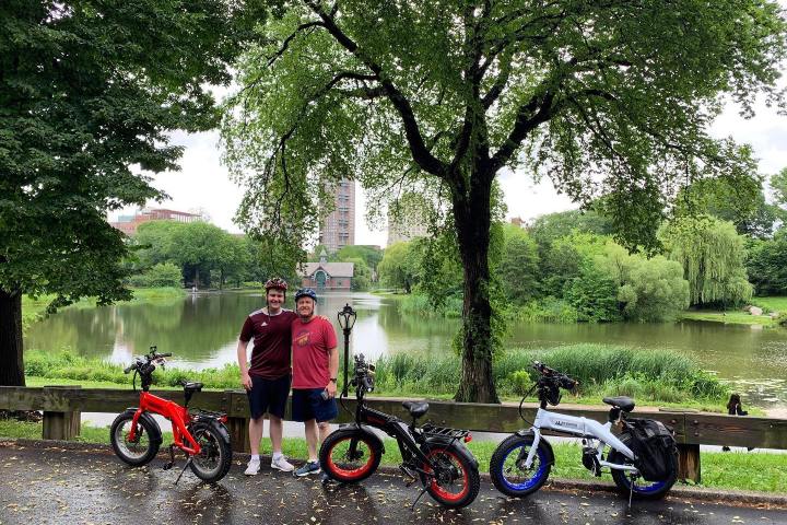 a group of people sitting on a bench in a park