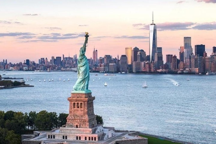 statue of liberty with water at sunset