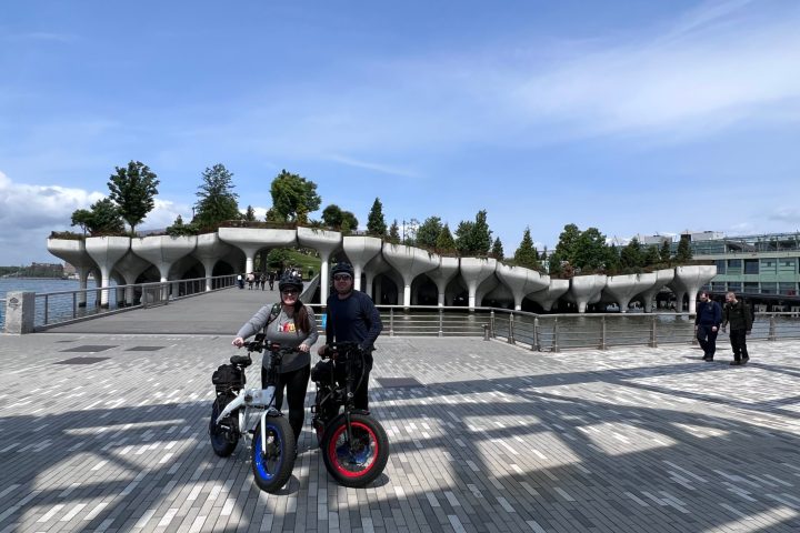 a group of people on a motorcycle in a parking lot