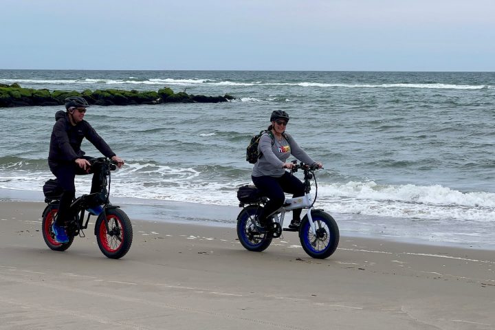 a person riding a motorcycle on a beach
