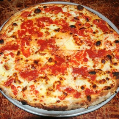 Thin crust pizza with cheese and tomato sauce, served on a metal pan